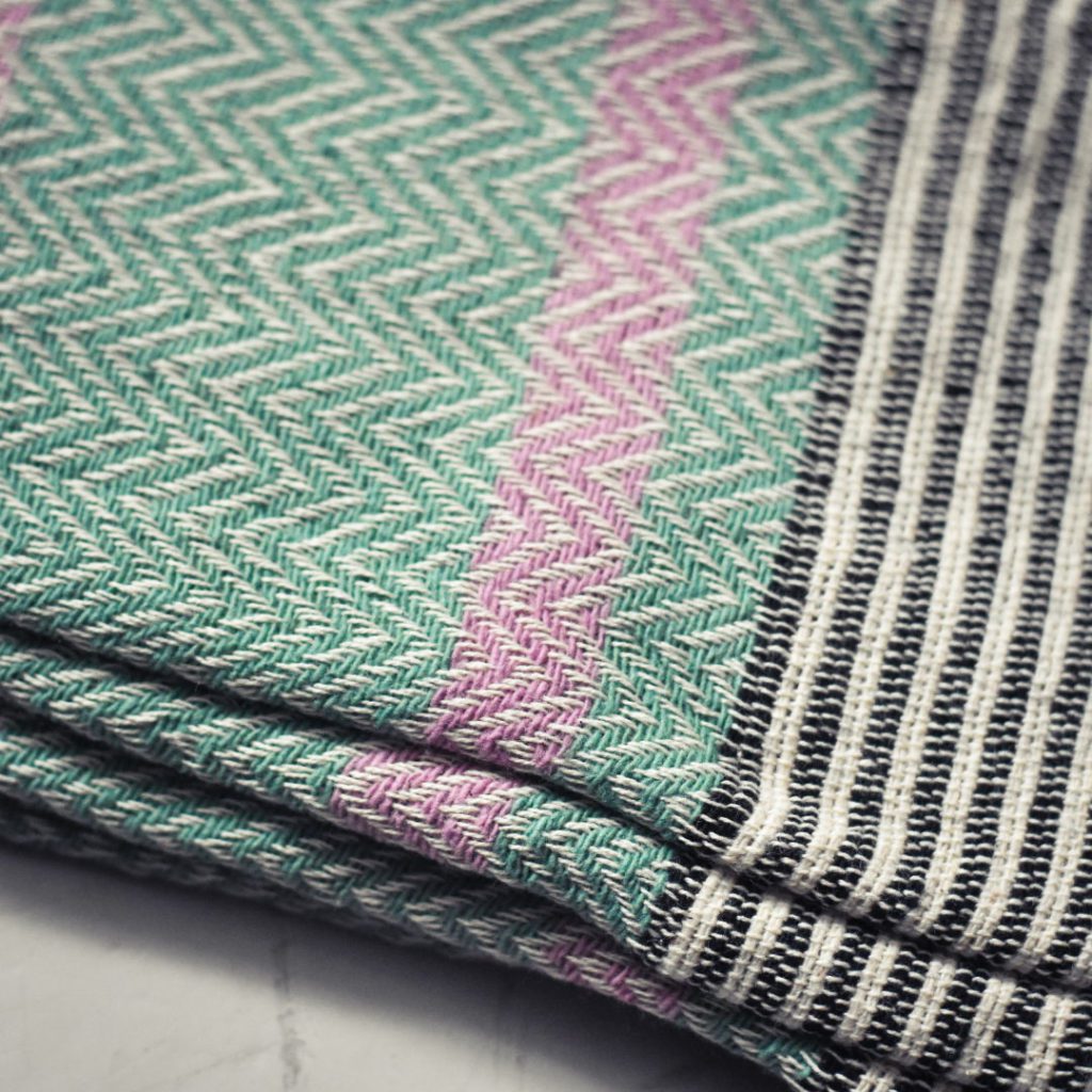 Close up of ethical peppermint green throw