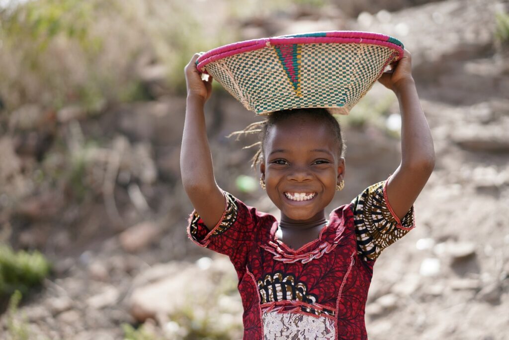 Smiling child holding a basket
