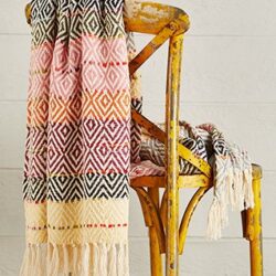 Colourful handloomed throw with diamond pattern over a chair